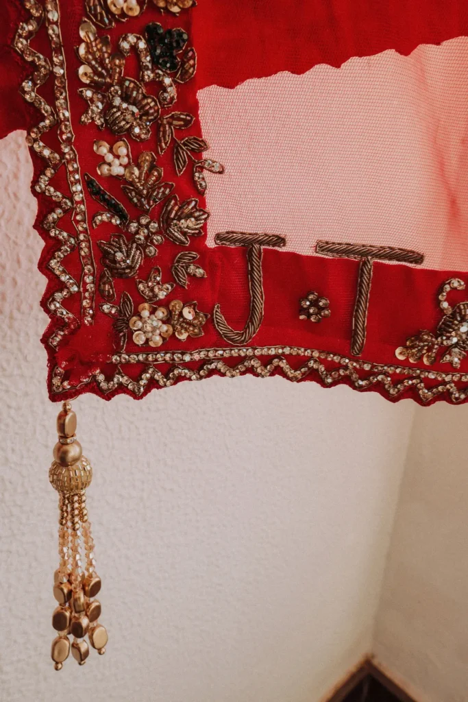 traditional red lehenga marked couples name